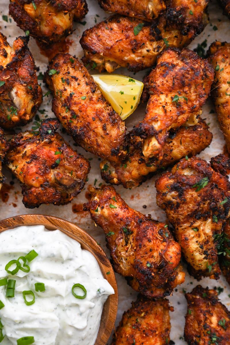 Spicy Cajun chicken wings with a side of ranch dressing.