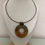 Miniaturbild: Brown agate circle pendant on metal cord, front view.