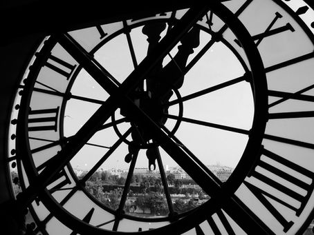 A Church clock through which a city is visible.