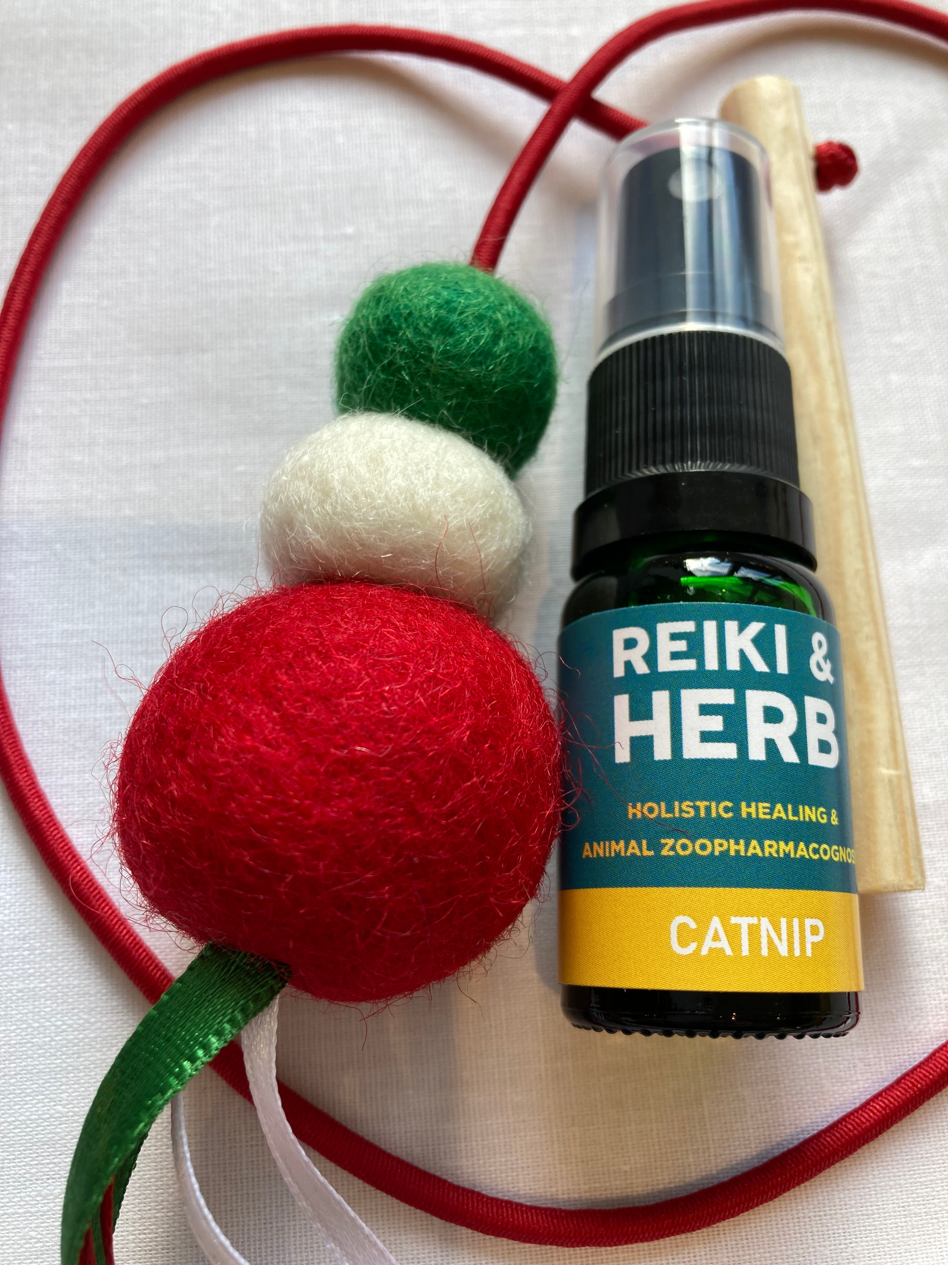 Reiki & Herb bottle, red and green felt balls with visible text.