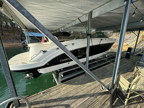 Boat on a lift under a covered dock on Lake Lanier