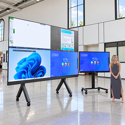 Presenter beside a Drive-In LED video wall and LiteTouch panel demonstrating shared content in a bright atrium.
