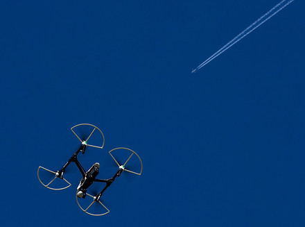 DJI Inspire 1 during a flight with aircraft con trails far above.