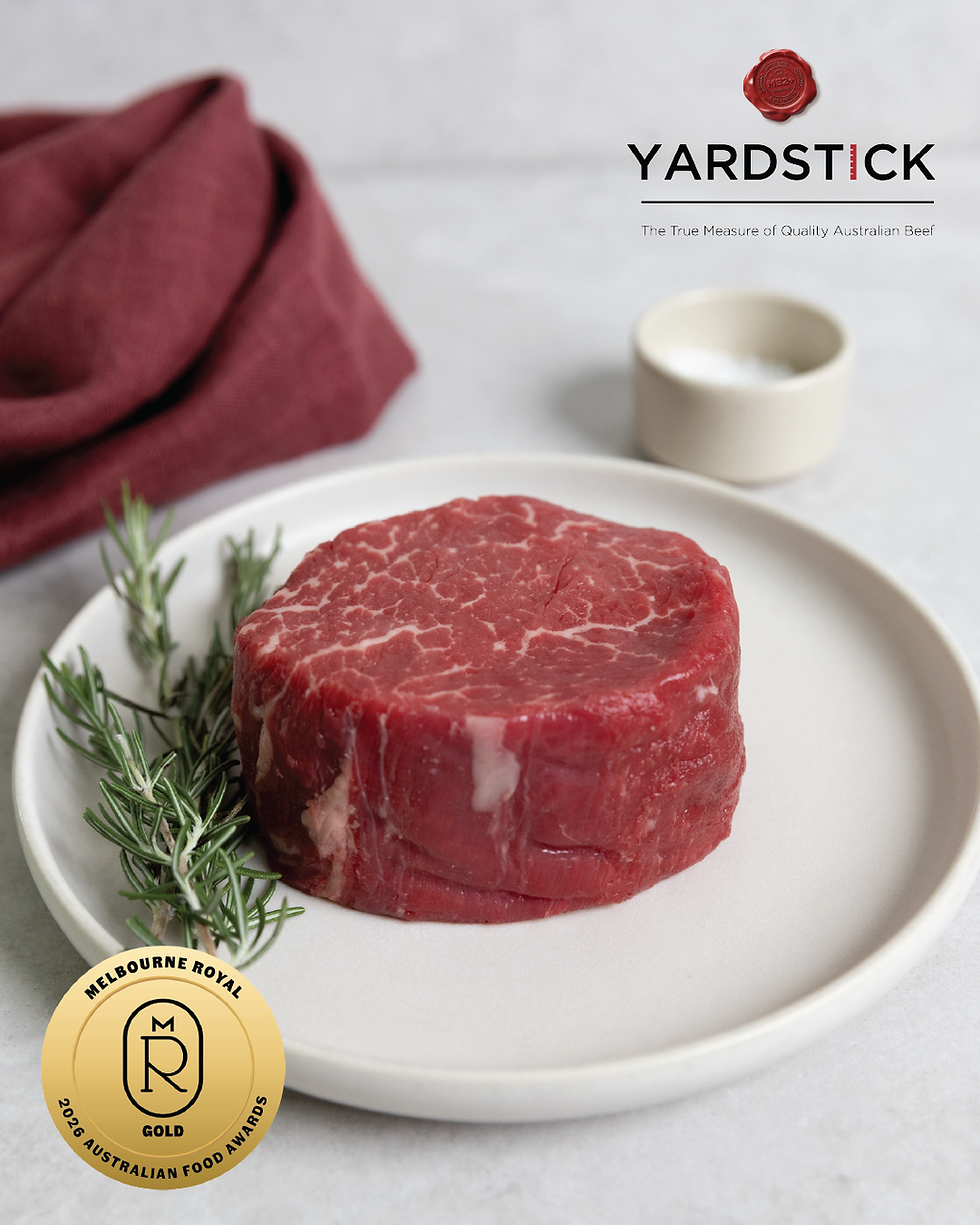 Raw beef steak on white plate with rosemary; Yardstick logo and tag line at top right, Melbourne Royal gold award badge bottom left.