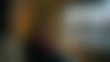 Woman sitting by Christmas tree looking sad