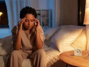 A woman experiencing insomnia in Frederick, MD seeks safer methods for achieving better sleep.