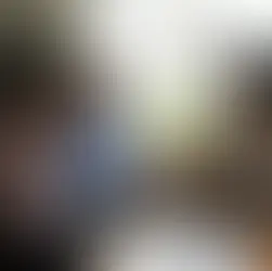 A therapist discusses depression warning signs with concerned parents and a teenager during a counseling session at home.