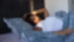 A woman lying awake in bed during early morning light, illustrating the struggle of insomnia and its impact on mood and mental health.