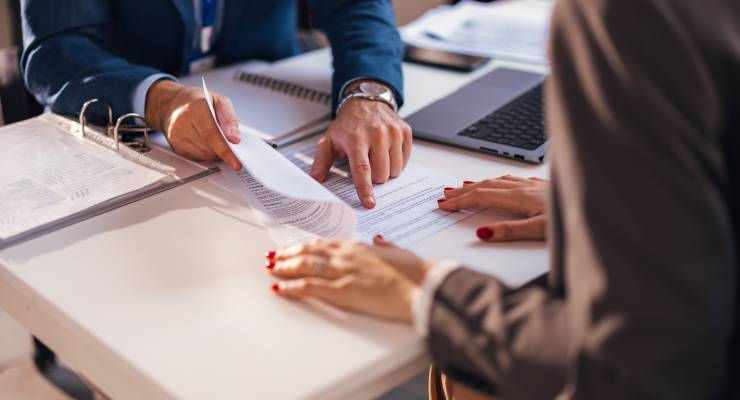 A lawyer going over the contract with a client