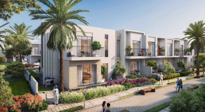 A row of contemporary townhouses surrounded by lush green landscaping in Dubai.