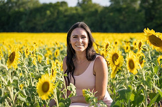 Julie in a field of sunflowers.jpeg