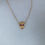 Thumbnail: Ruby Eyed Skull Necklace - Gold