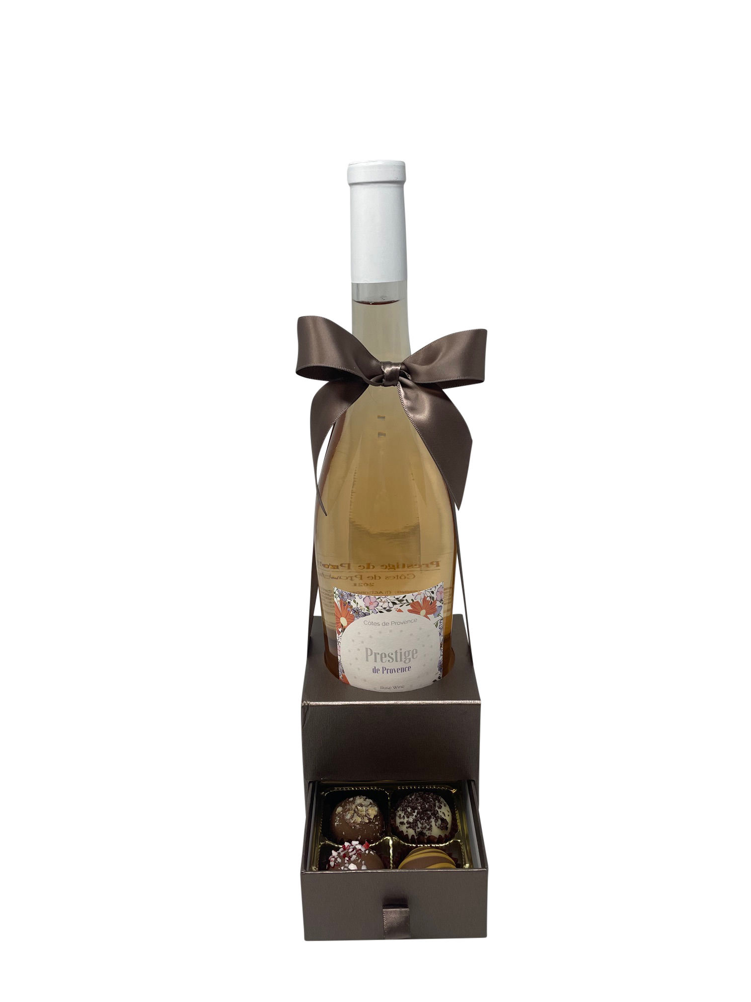 White wine bottle with brown ribbon and chocolate gift box.