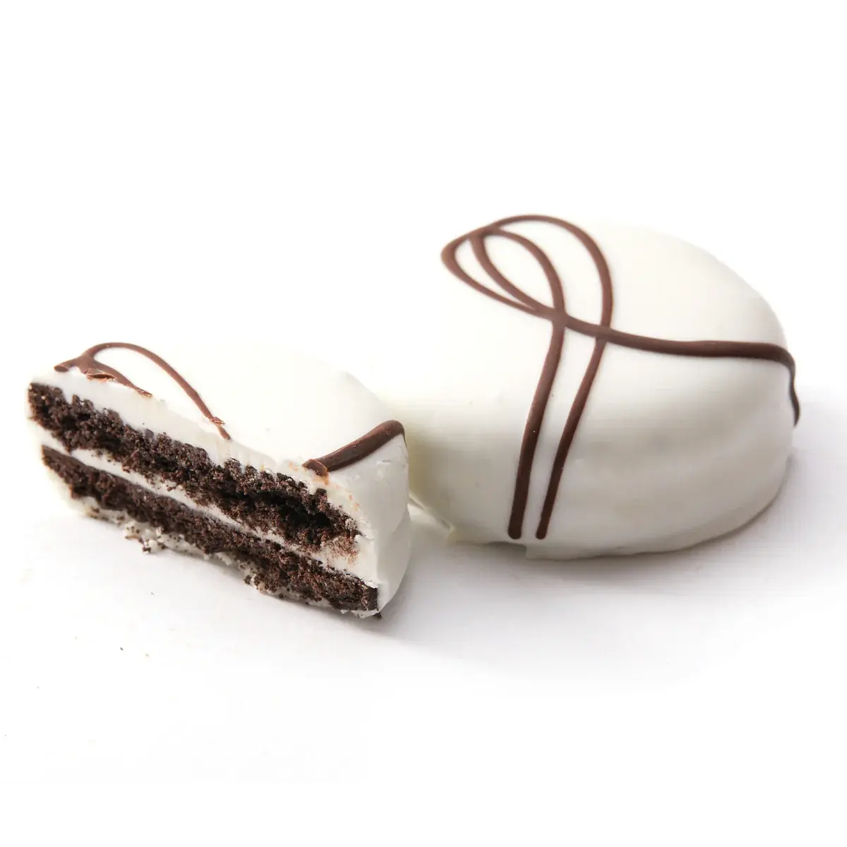 Sliced mini ice cream cake with chocolate sprinkles, white frosting and layers.