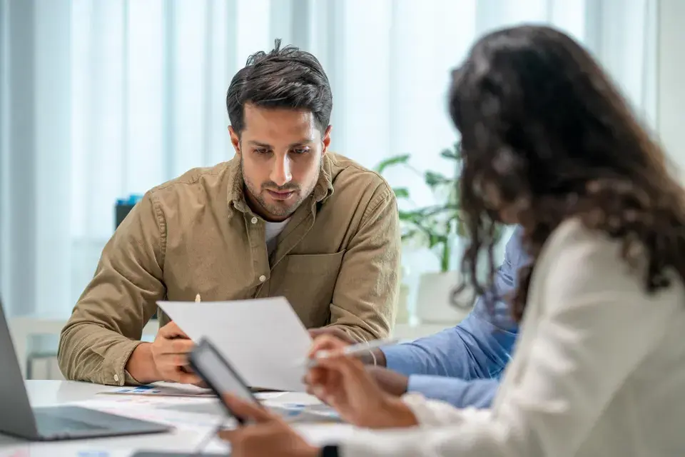 Business professionals reviewing financial reports during a fractional CFO strategy meeting