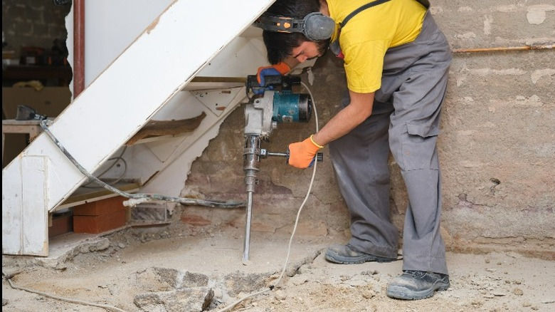 Jackhammering concrete slab