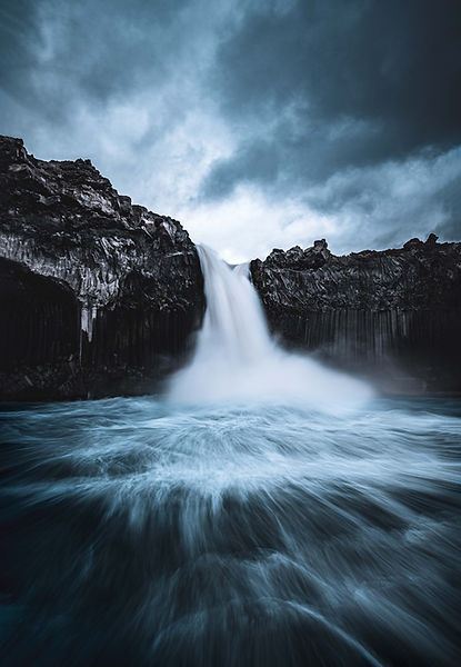 ALDEYJARFOSS, big waterfall with blue sky and blue water with dramatic cliffs around it