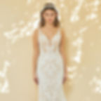 Girl standing in a white sheath wedding dress with unique lace and a v-line neckline