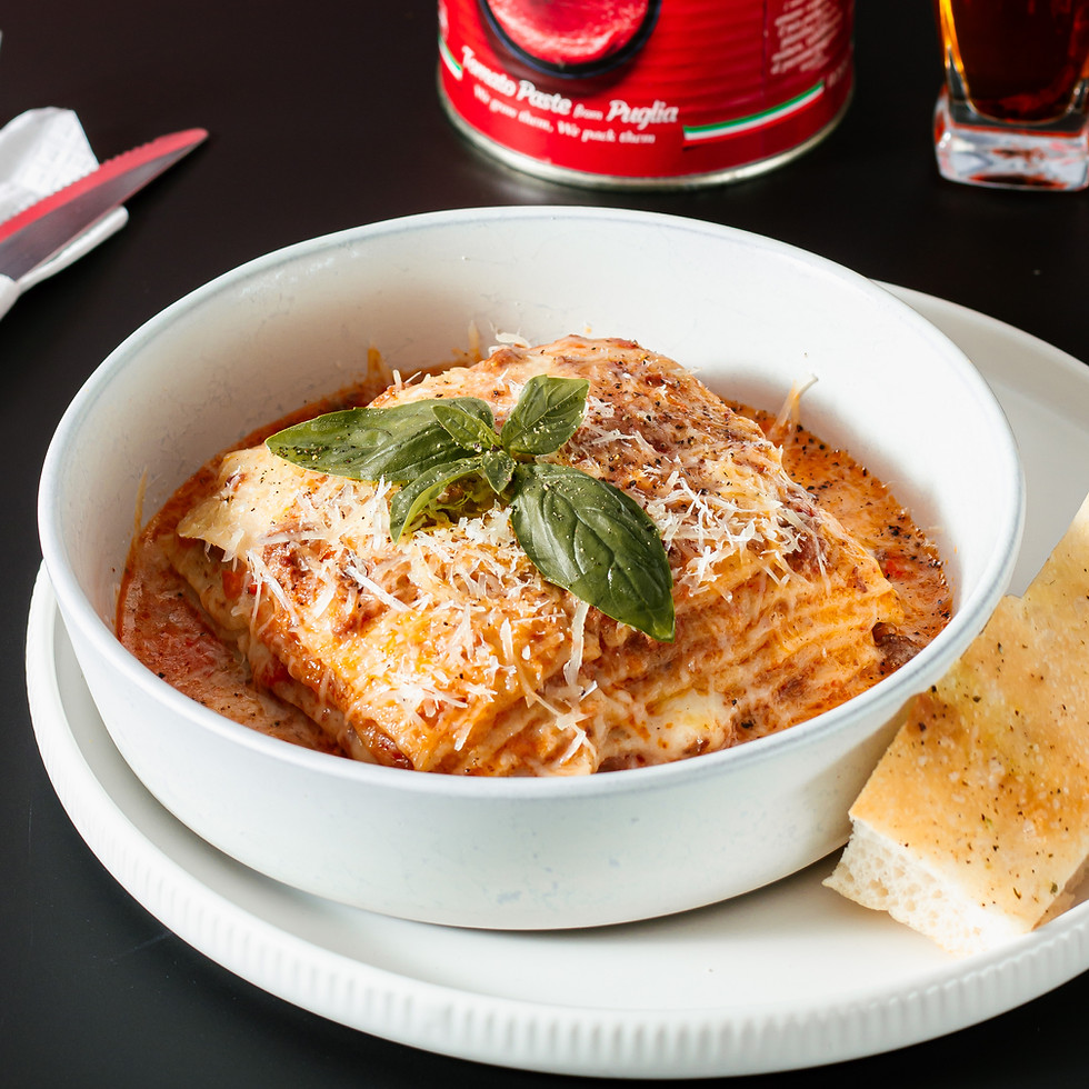 Meat lasagna in a bowl served with bread