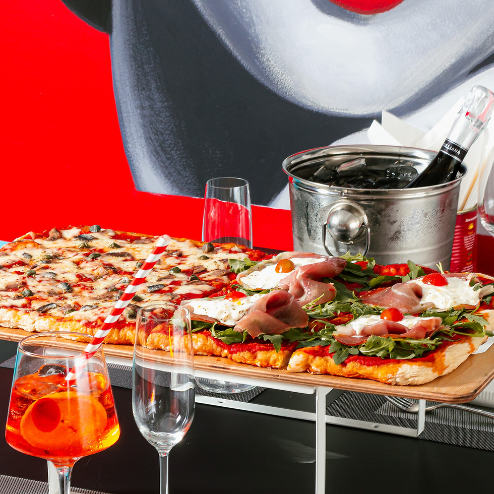 Table with a large 1 meter pizza and drinks at an italian restaurant