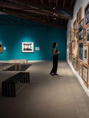 Visitor exploring a summer exhibition at The Whyte, Thick as Thieves, in Banff, Alberta.