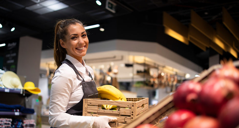 Grocery merchant lady holding wooden crate store smiling produce fruit vegetables