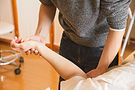Physiotherapist gently examining patient's arm