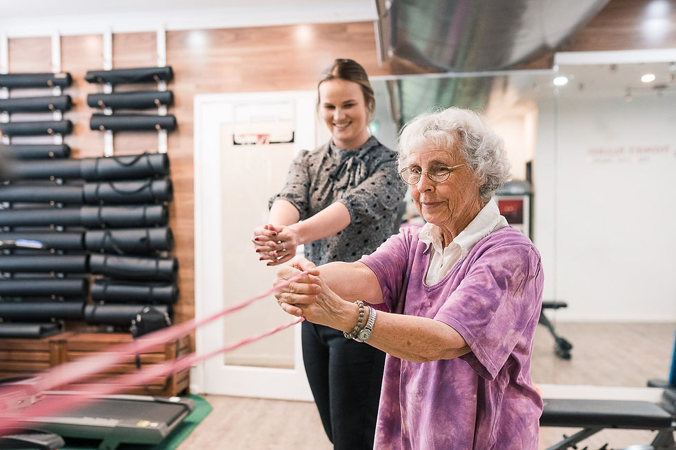 Senior woman exercising with therapist using resistance band