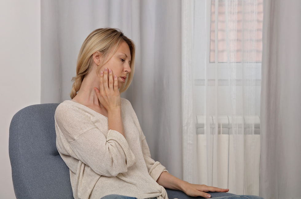 Woman experiencing jaw pain, seeking relief