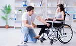 Man assisting woman in wheelchair; physiotherapy
