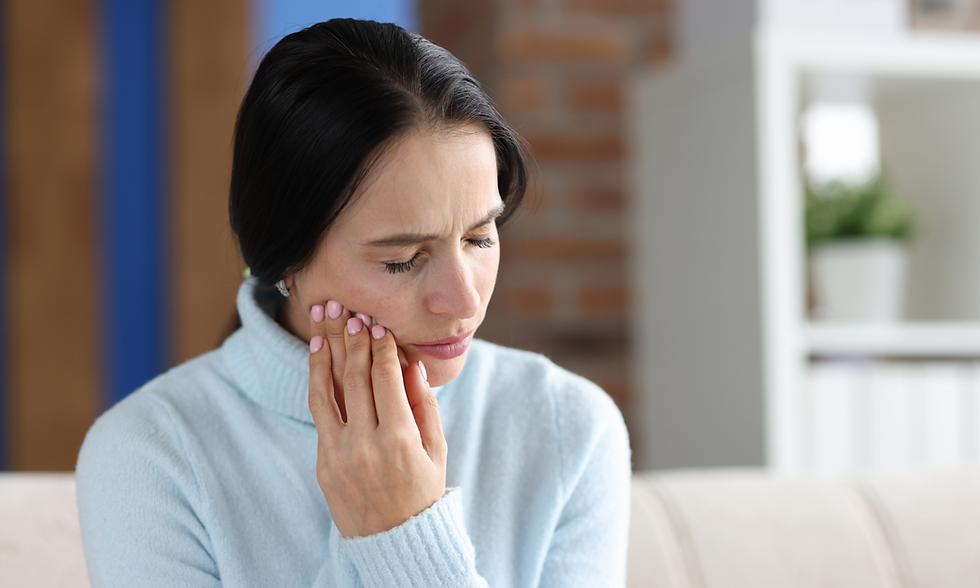 Woman experiencing TMJ pain, holding her jaw