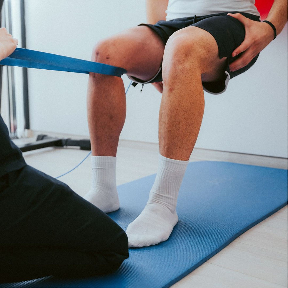 Physiotherapist assisting patient with knee exercise