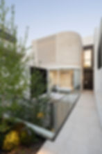 Modern home's courtyard design with glass walkway