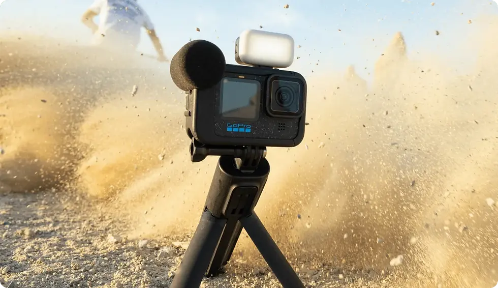 A GoPro 12 Action Camera standing on a tripod covered surrounded by dust