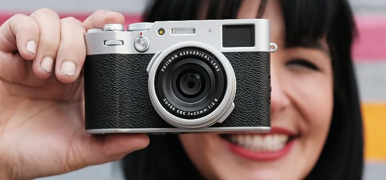 A beautiful smiling woman holding a Fujifilm Mirrorless Camera