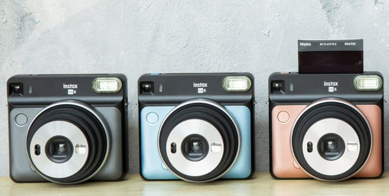 three Fujifilm Instant Cameras standing beside each other