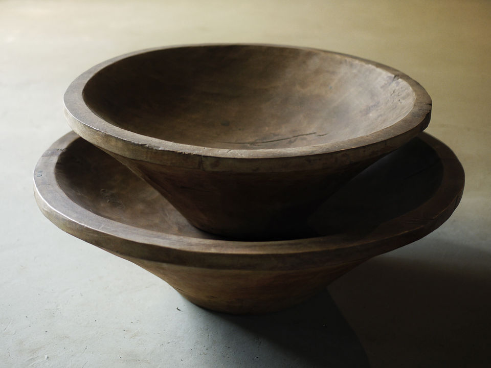A pair of Teak wood decorative bowls on concrete background 