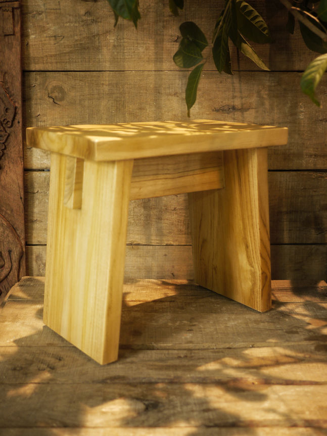 Japanese wooden bath stool on a wooden background