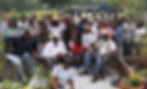 group of people sitting in a garden