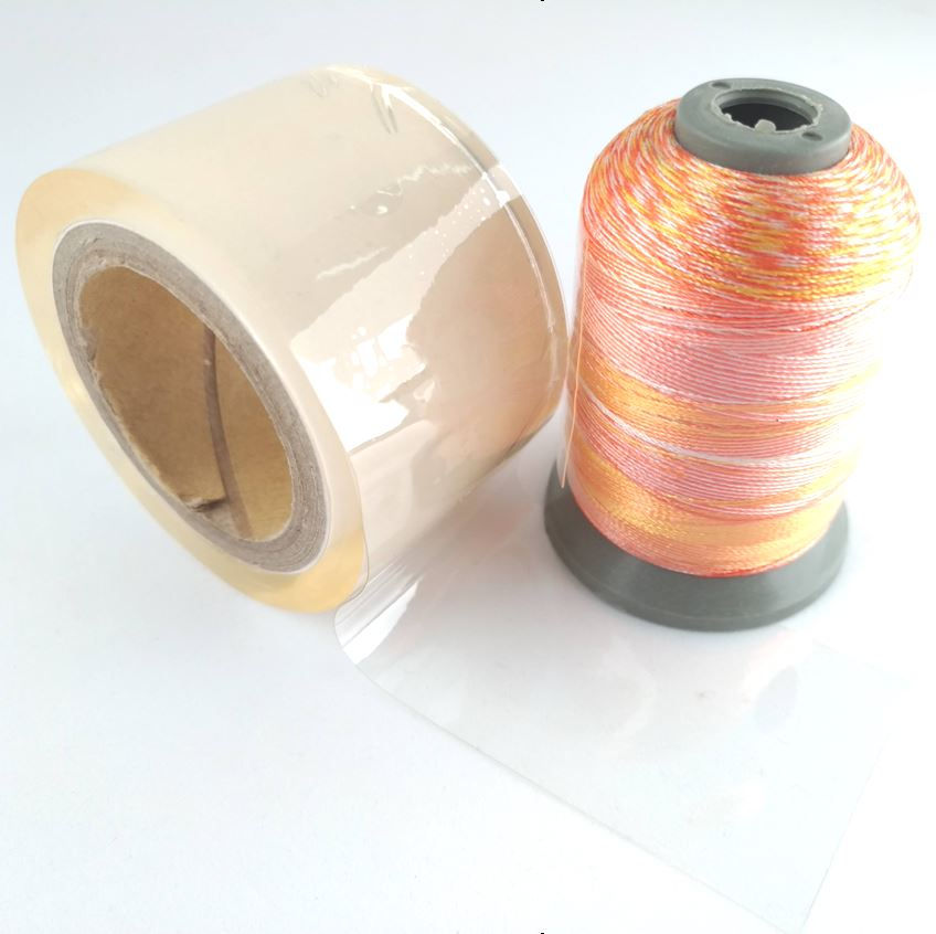 Thumbnail: roll of Unique brand Incredible Cling Tape shown beside wrapped thread spool