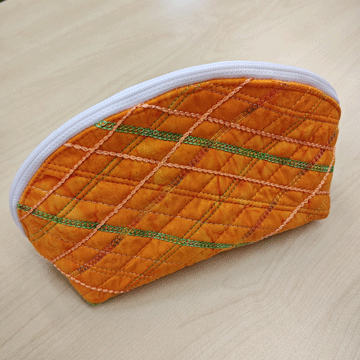 stitch-embellished orange zippered pouch