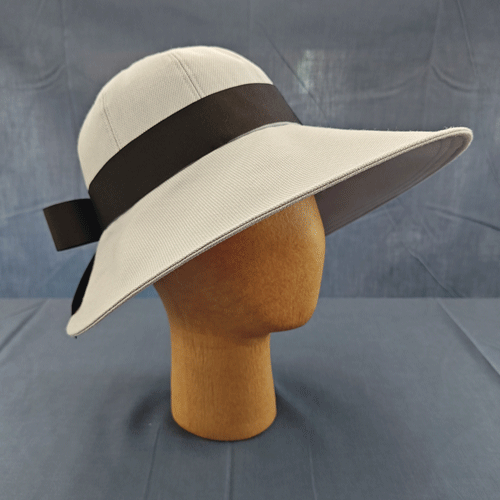 a pale grey garden-tea hat with a contrasting black ribbon band