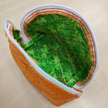 orange zippered pouch opened to show green interior