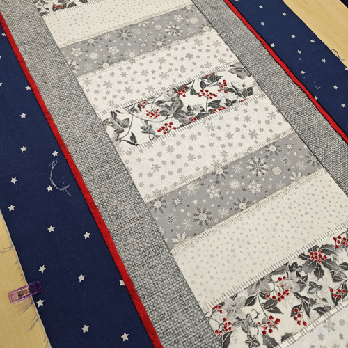 Tammy's blue and silvers table runner accented with a thin red zinger