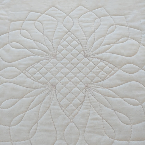 ruler-quilted block motif on muslin quilt