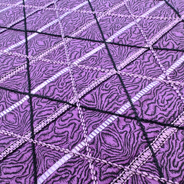 lavender and black stitch embellishment on purple fabric