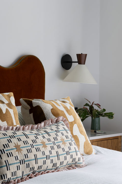 Quiet luxury bedroom interior with upholstered headboard, soft neutral palette and tailored joinery.