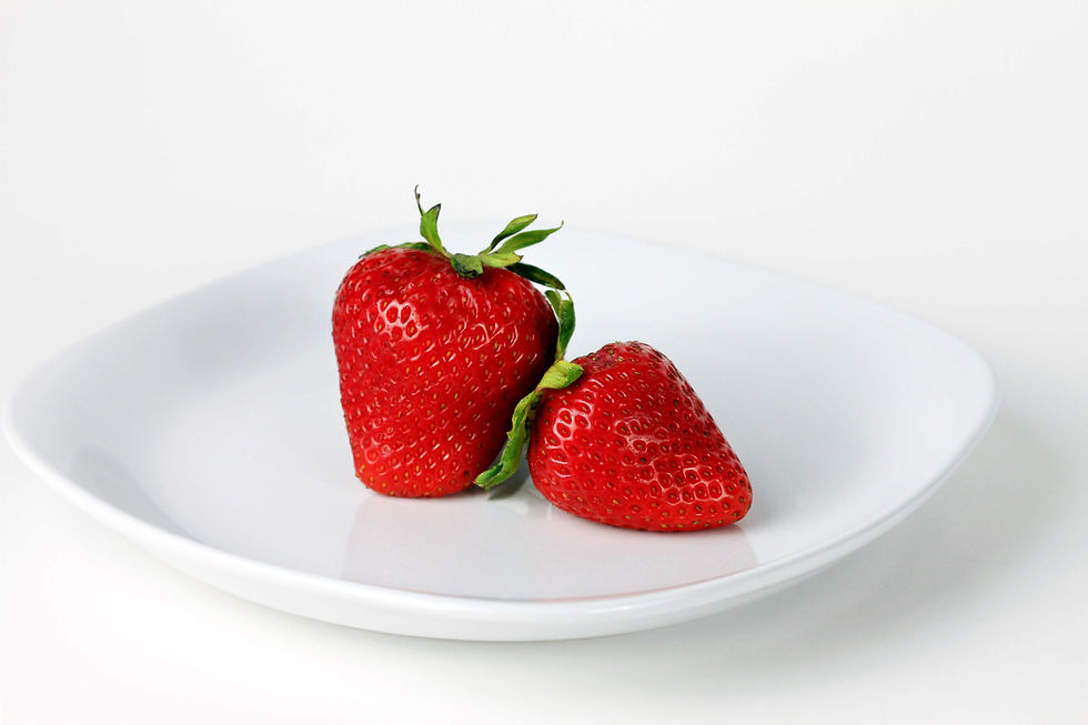 two strawberries on white plate