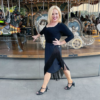 Asymmetrical black skirt with fringe.