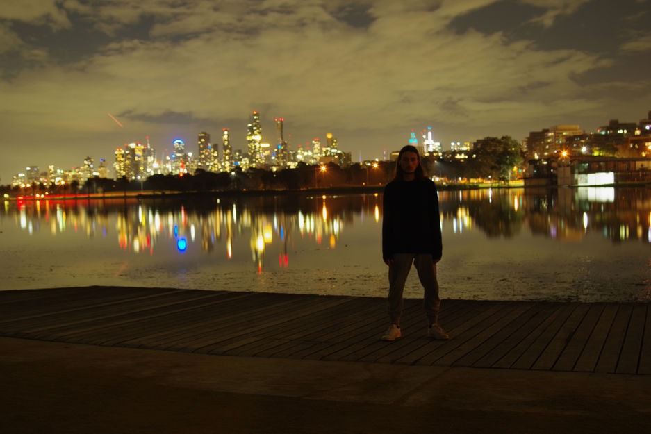 Manny alone by lake, night, city lights, sadness, misery, pain, suicide. reflections
